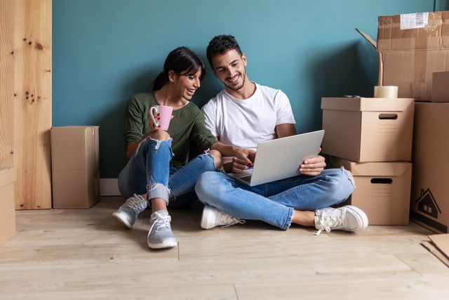 Couple Looking Decoration Ideas With Laptop While Drinking Coffe